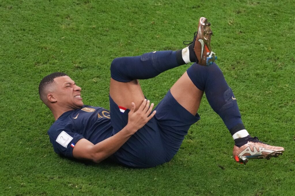 France's Kylian Mbappe lies injured during the FIFA World Cup Qatar 2022 final match against Argentina at Lusail Stadium, Lusail City, Qatar, Dec. 18, 2022. (Getty Images Photo)