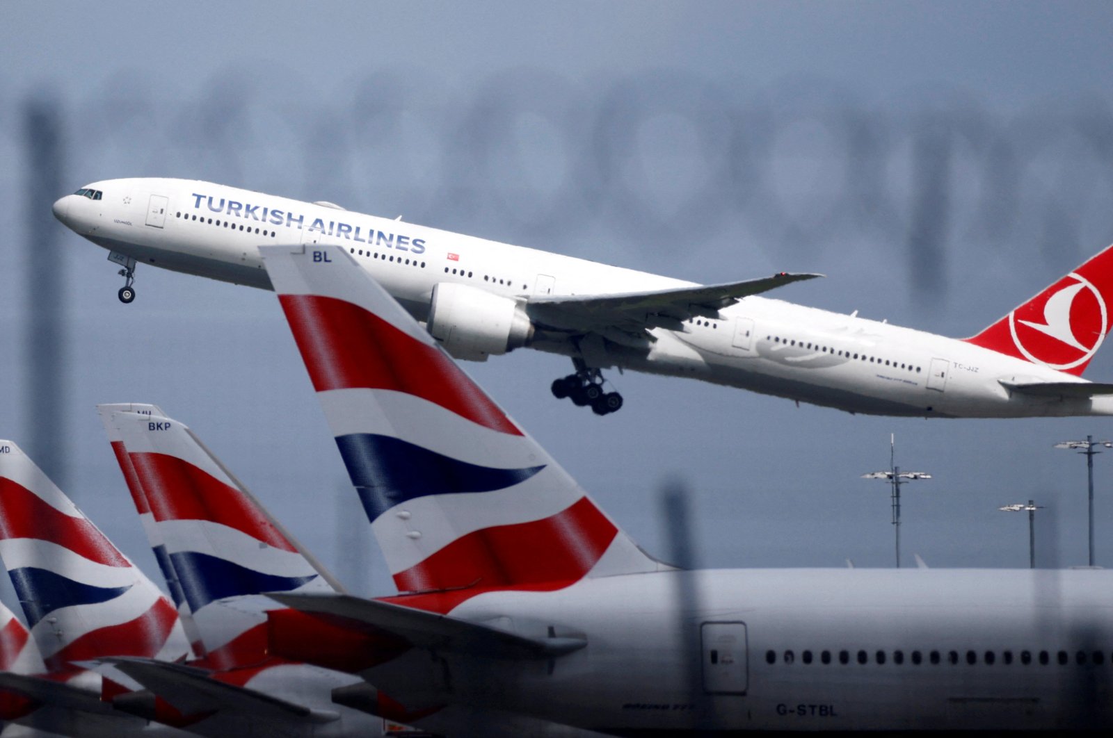 A Turkish Airlines Boeing 777 takes off past parked British Airways aircraft at Heathrow Airport, London, Britain, May 17, 2021. (Reuters Photo)