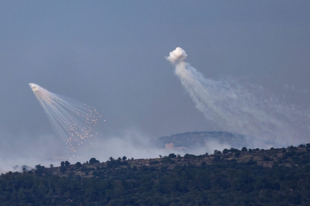 A picture taken from the Israeli side of the border with Lebanon shows shells exploding over hills around the southern Lebanese village of Aita al-Shaab, Dec. 8, 2023. (AFP Photo)