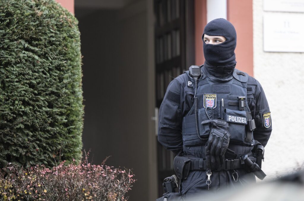 Police officers stand by a searched property in Frankfurt during a raid against so-called 'Reich citizens' in Frankfurt, Germany, Dec. 7, 2022. (AP Photo)