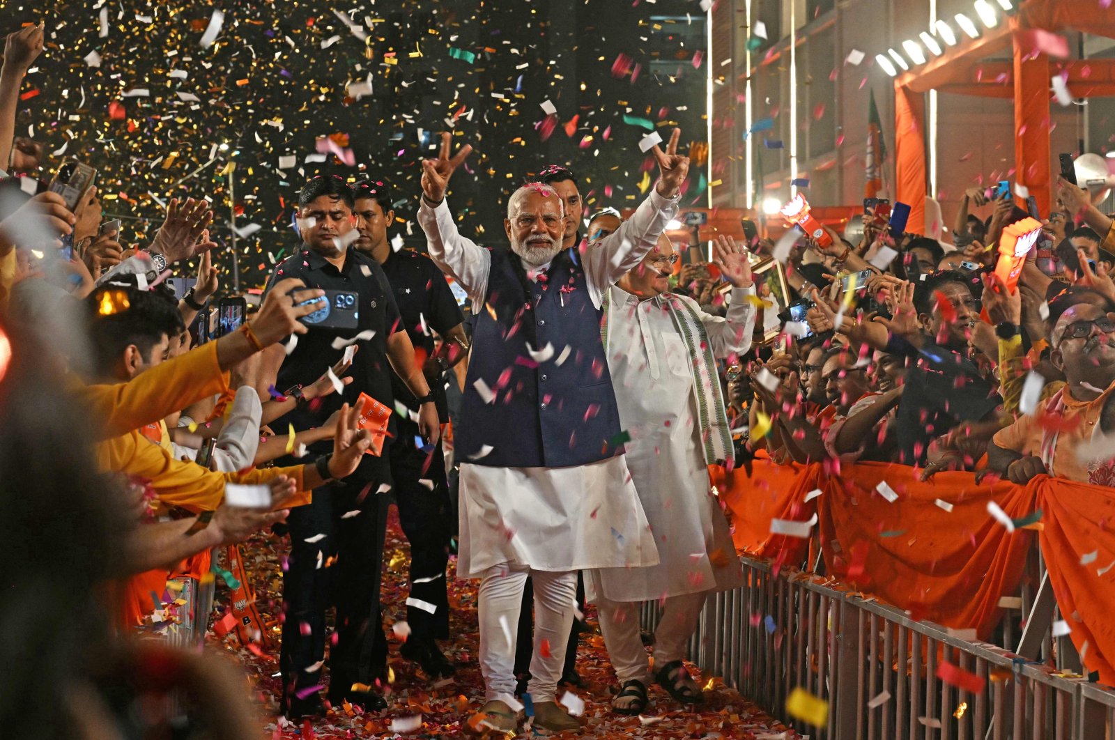 India’s Prime Minister Narendra Modi (C) flashes victory sign as he arrives at the Bharatiya Janata Party (BJP) headquarters, in New Delhi, India, June 4, 2024. (AFP Photo)