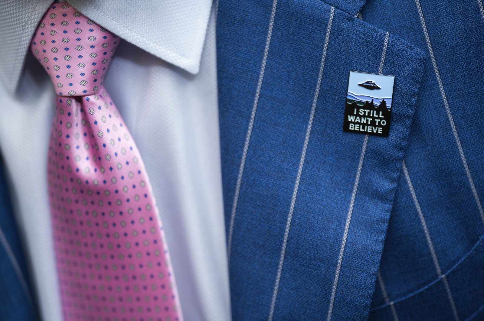An audience member wears a UFO pin during a House Oversight and Accountability subcommittee hearing on UFOs, on Capitol Hill in Washington, D.C., July 26, 2023. (AP Photo)