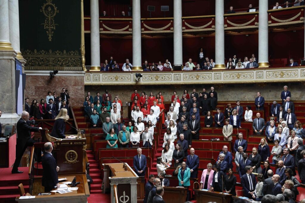 French members of Parliament stand during a session of questions to the government at the National Assembly, after French Member of Parliament of "La France Insoumise" (LFI) group Rachel Keke waved a Palestinian flag in the Assembly Chamber in Paris on June 4, 2024. (AFP Photo)