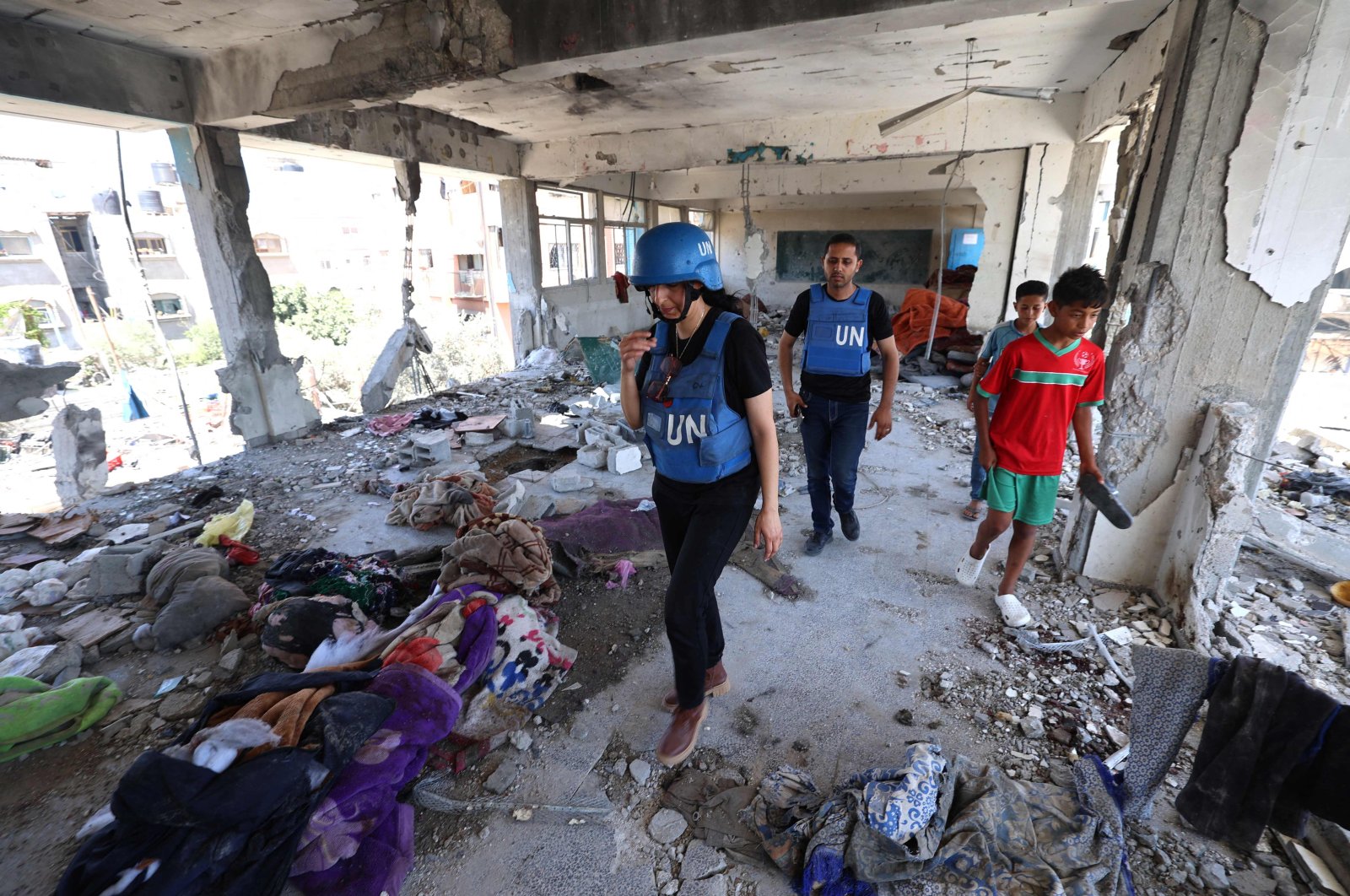 Members of a United Nations investigation team visit a school run by the UN Relief and Works Agency for Palestine Refugees (UNRWA) which was hit during an Israeli army strike the day before, in the Nuseirat camp in the central Gaza Strip, June 7, 2024. (AFP Photo)