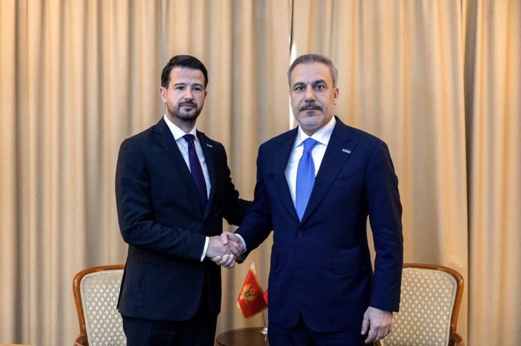 Foreign Minister Hakan Fidan and Montenegro's President Jakov Milatovic shake hands in Skopje, June 13, 2024. (IHA Photo)