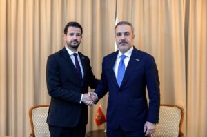 Foreign Minister Hakan Fidan and Montenegro's President Jakov Milatovic shake hands in Skopje, June 13, 2024. (IHA Photo)