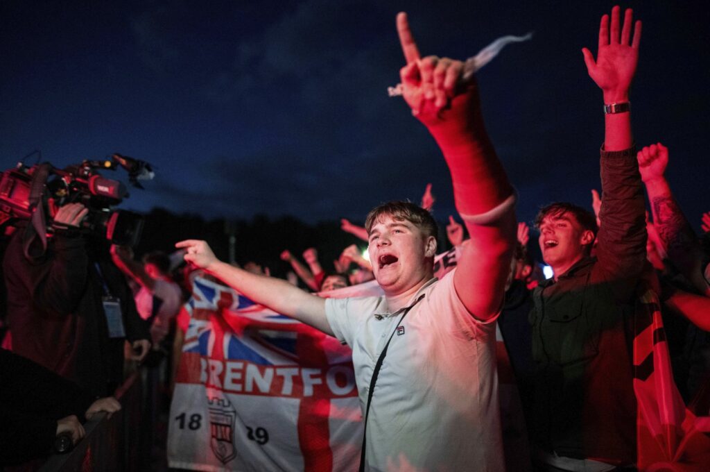 England fans celebrate at the end of a Group C match against Serbia at the Euro 2024 tournament during a public viewing, Gelsenkirchen, Germany, June 16, 2024. (AP Photo)
