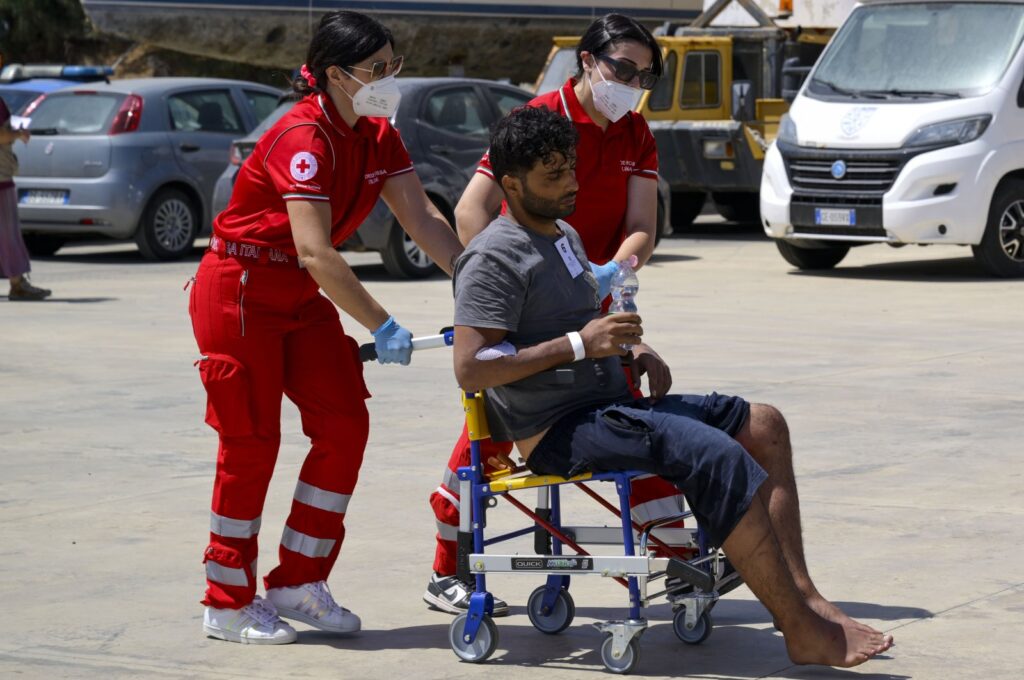 One of the 11 migrants saved from the sea is assisted by emergency workers in Roccella Ionica, southern Italy, June 17, 2024. (AP Photo)