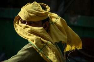 A man riding a two-wheeler looks on as he covers his face with a cloth on a hot summer day amid a severe heatwave in Varanasi, India, May 30, 2024. (AFP Photo)