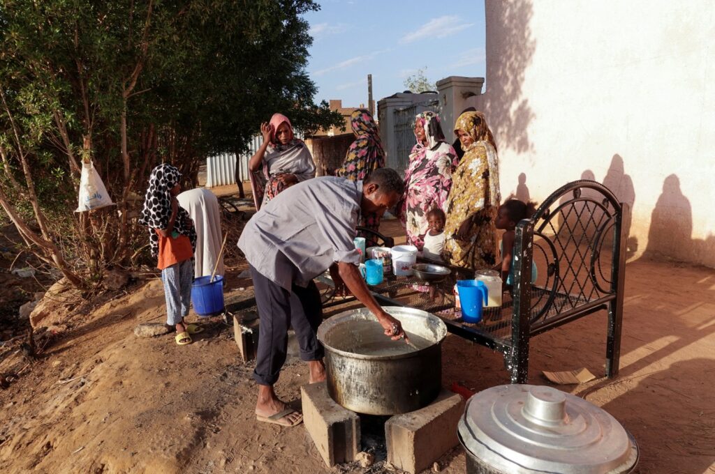 Displaced Sudanese families wait to receive food from a charity kitchen in the city of Omdurman, Sudan, April 6, 2024. (Reuters File Photo)