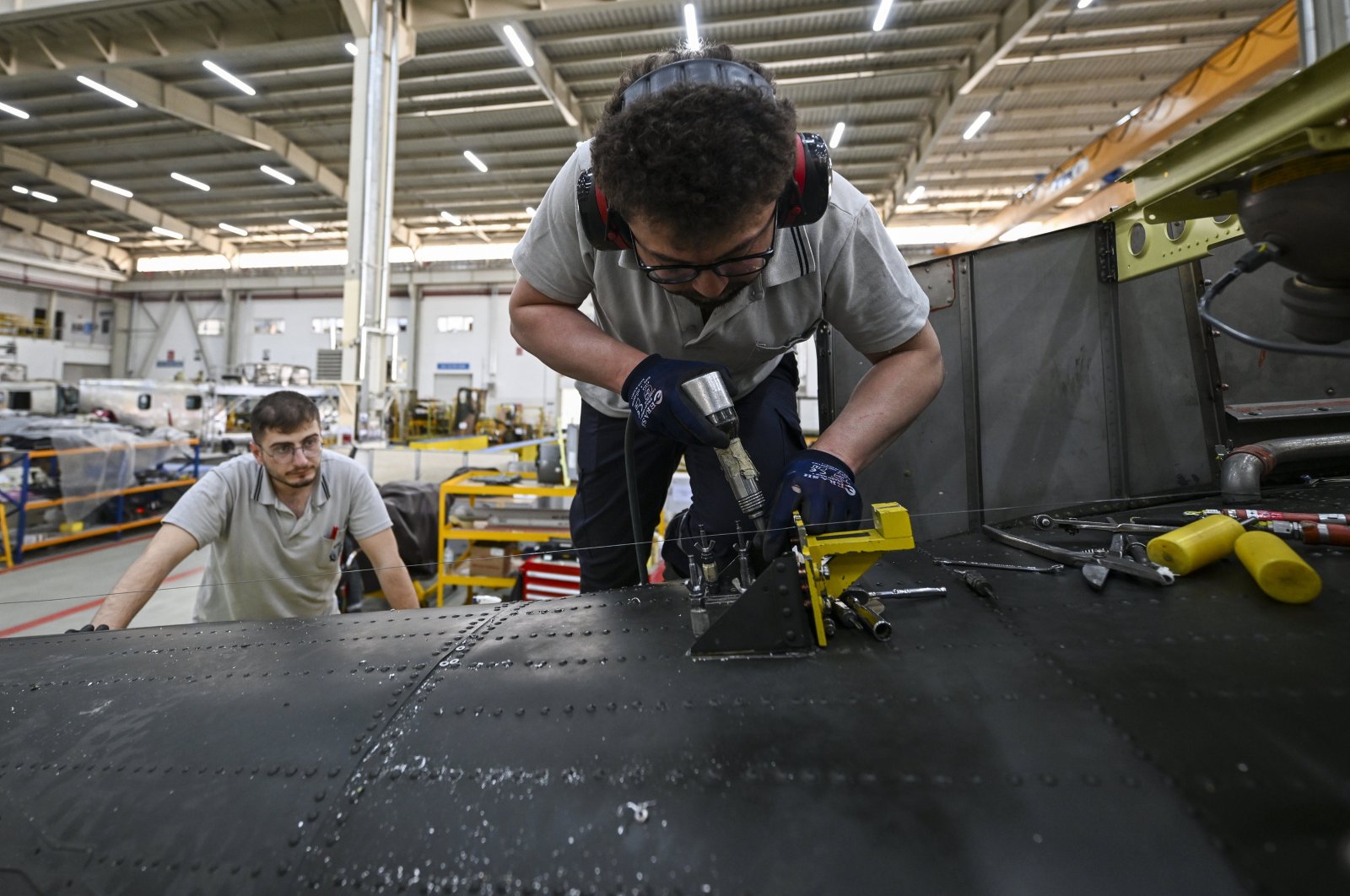 A worker is photographed in the 5th Main Maintenance Factory Directorate, affiliated with the General Directorate of Military Factories of the Ministry of National Defense, which carries out the maintenance, repair and modernization of aircraft, Ankara, Türkiye, June 12, 2024. (AA Photo)