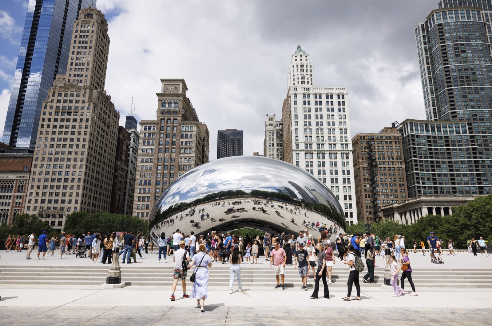 Visitors take photos of the "Cloud Gate" sculpture, also known as the "Bean," at Millennium Park, Chicago, U.S., June 23, 2024. (AP Photo)