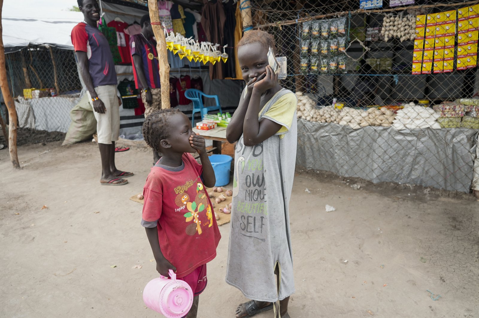 Children laugh in a market in Kowach village in Canal Pigi county, Jonglei State, South Sudan, May 5, 2023. (AP Photo)