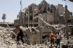 Palestinians walk at the site of Israeli strikes that hit a residential building and destroyed shops at Gaza's Old City market, Gaza, Palestine, July 4, 2024. (Reuters Photo)