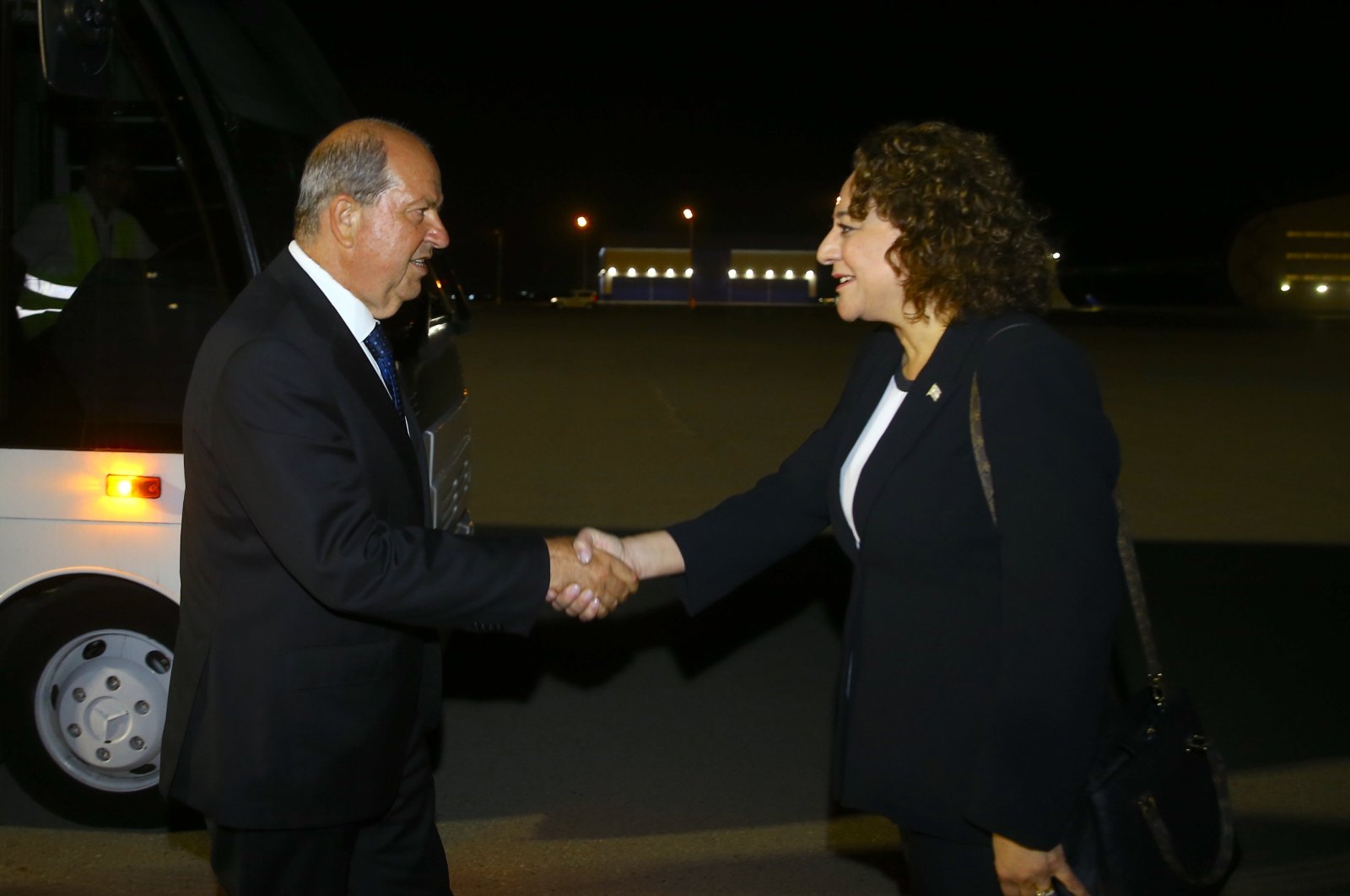 TRNC President Ersin Tatar (L) shakes hands with his country's representative in Baku, Ufuk Turganer (R), as he arrives at the Heydar Aliyev International Airport, Azerbaijan, July 4, 2024, (AA Photo)