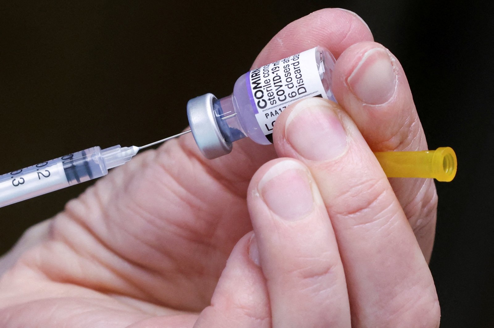 A medical staff member prepares a booster dose of Pfizer's COVID-19 vaccine at a vaccination center, Brussels, Belgium, Jan. 5, 2022. (Reuters Photo)