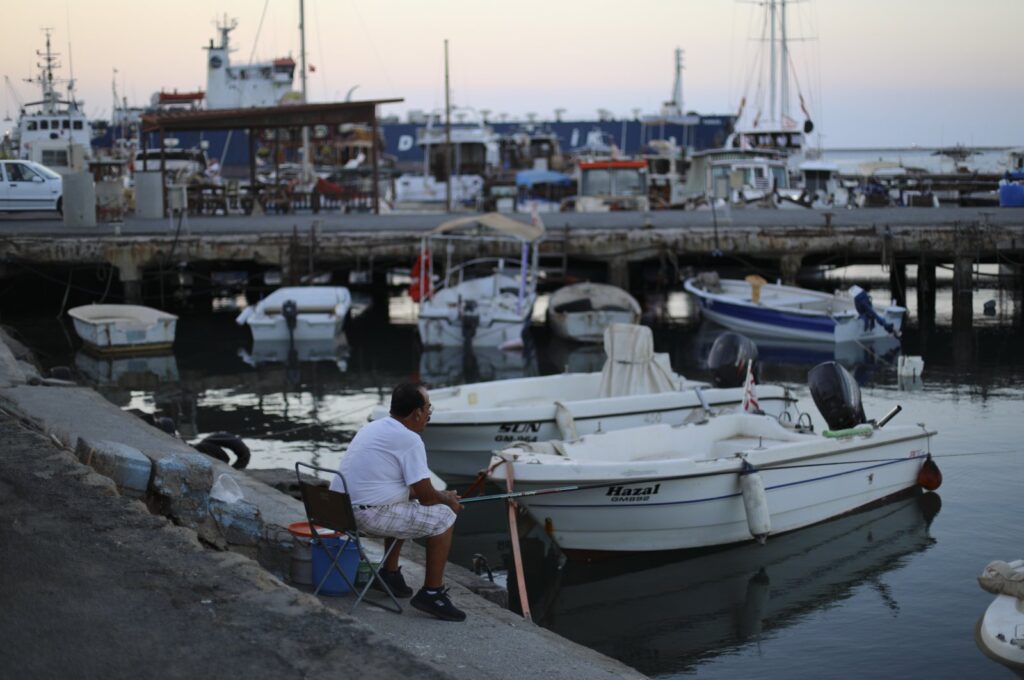A man fishes in the port of Gazimağusa, in the Turkish Republic of Northern Cyprus, Aug. 14, 2022. (Reuters File Photo)