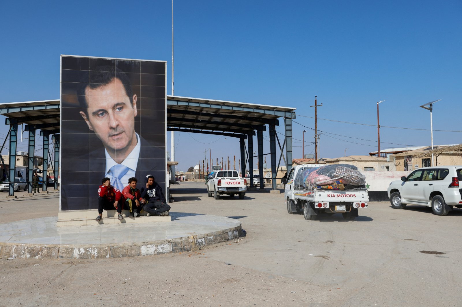 A picture of Syrian leader Bashar Assad is seen on a road where vehicles containing aid from Hashd al-Shaabi (Popular Mobilization Forces) head to Syria to support victims of the deadly earthquake, on the Syrian side of the Iraq-Syria border, Syria, Feb. 12, 2023. (Reuters Photo)