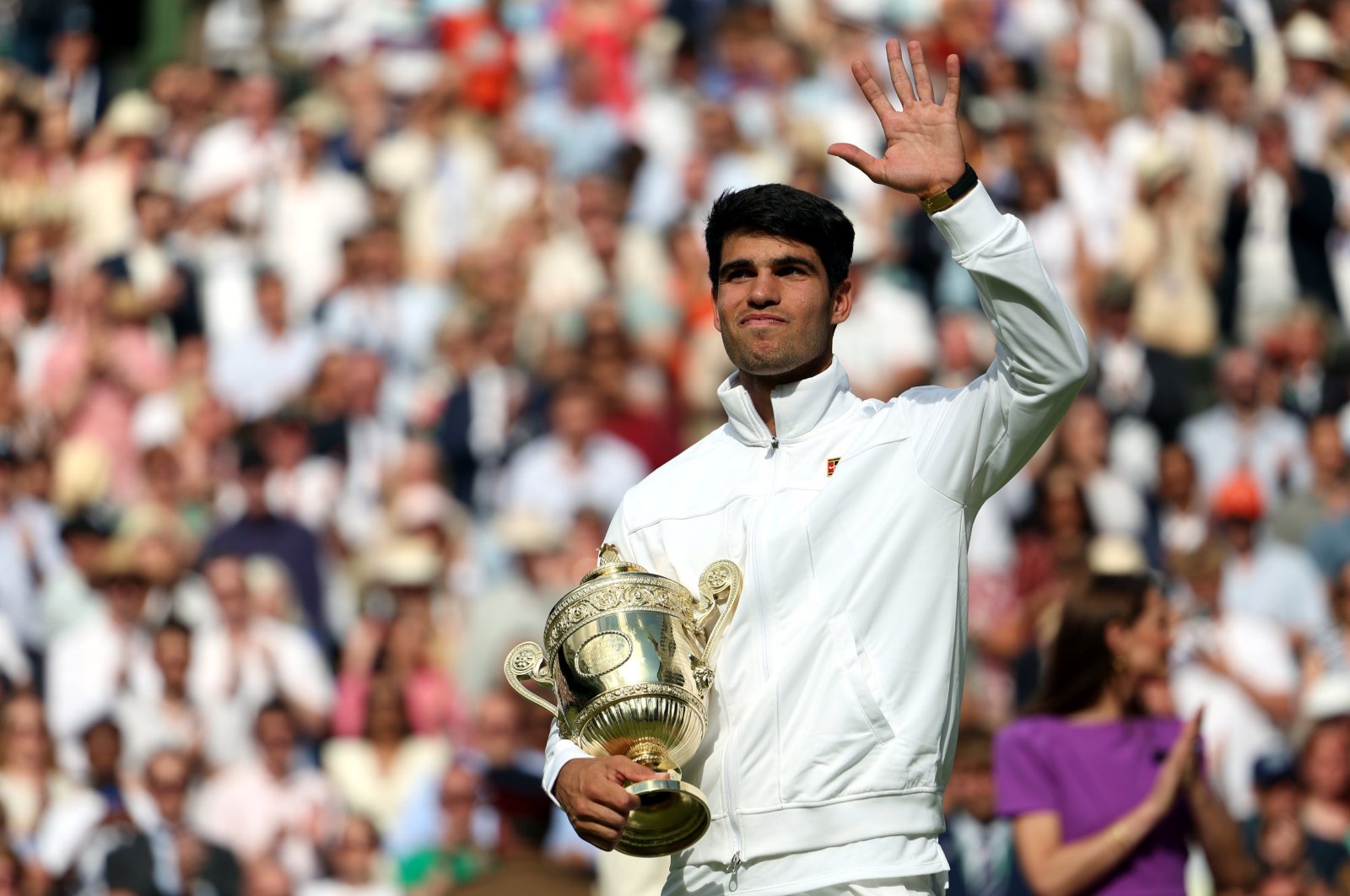 Spain's Carlos Alcaraz celebrates with his trophy after winning the men's final against Serbia's Novak Djokovic at the Wimbledon Championships, Wimbledon, London, U.K., July 14, 2024. (EPA Photo)
