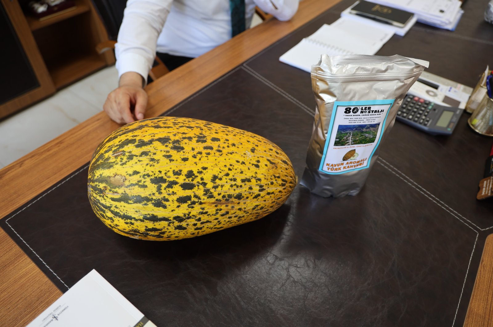 The famous Akıncılar melon and a packet of melon-flavored coffee (R) is seen on a counter, Sivas, Türkiye, July 15, 2024. (IHA Photo)