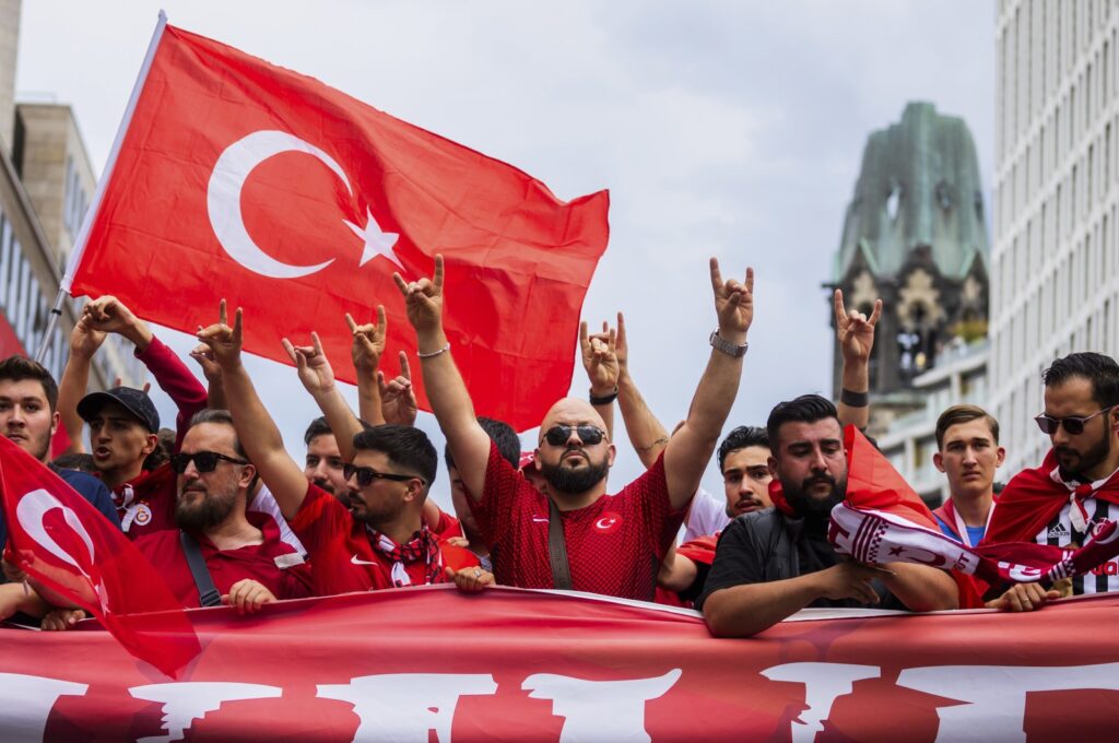 Turkish fans show the wolf sign during a fan walk before the start of the Euro 2024 match between Türkiye and Netherlands, Berlin, Germany, July 6, 2024. (AP Photo)