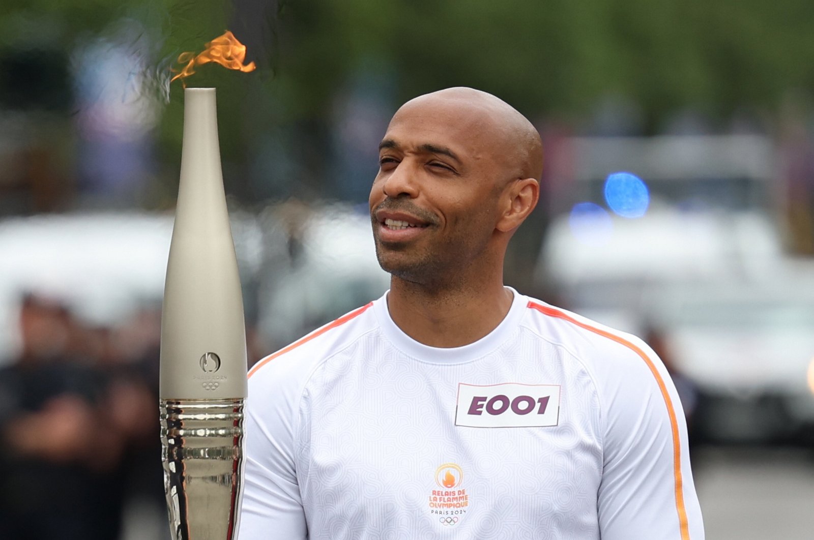 French football Olympics 2024 coach Thierry Henry holds the Paris 2024 Olympic flame as the Olympic Torch Relay arrives, Paris, France, July 14, 2024. (EPA Photo)