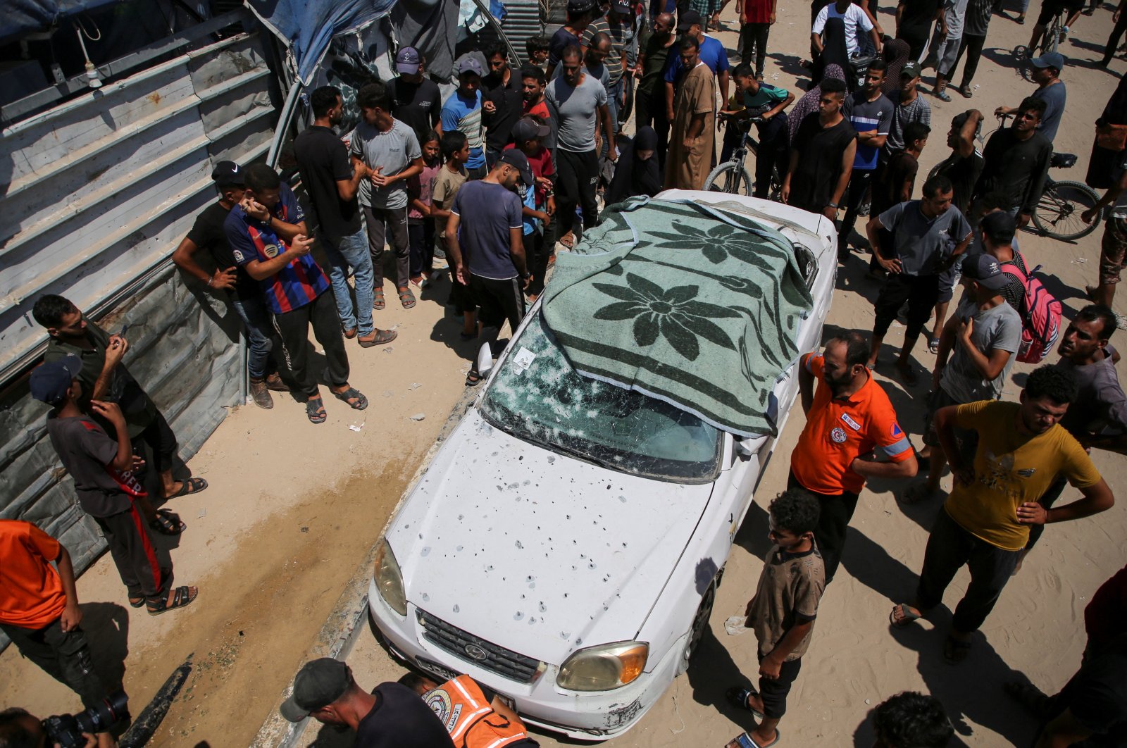 Palestinians gather at at the site of an Israeli strike at a tent camp in Al-Mawasi area, amid Israel-Hamas conflict, in Khan Younis in the southern Gaza Strip, July 16, 2024. (Reuters Photo)