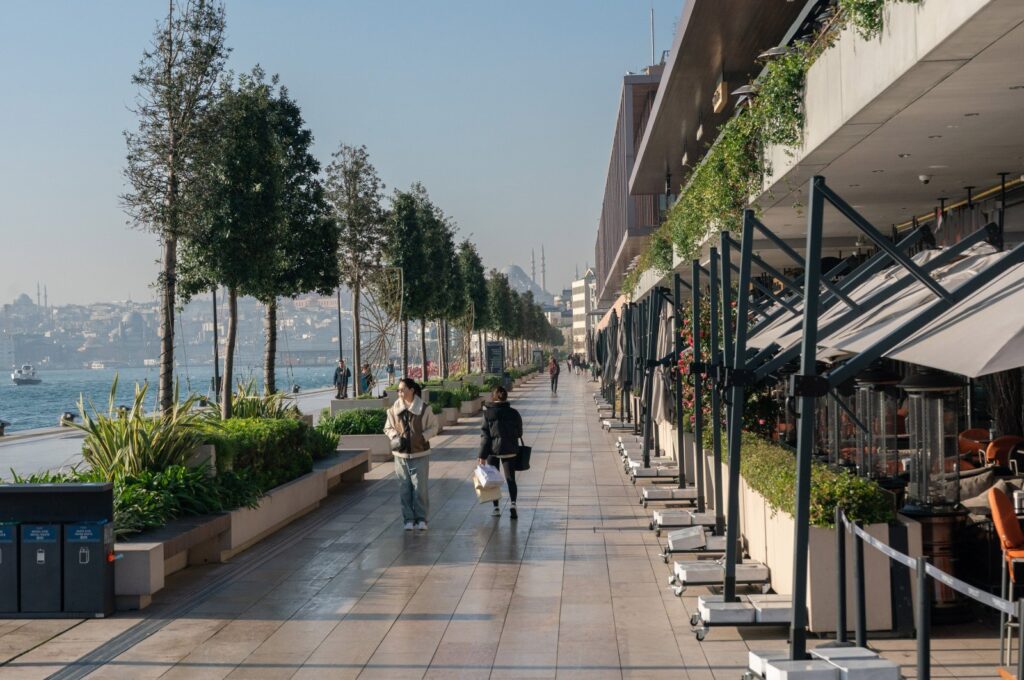 Pedestrians walk along the shores of the Bosporus next to restaurant terraces, Istanbul, Türkiye, Dec. 19, 2023. (Getty Images Photo)