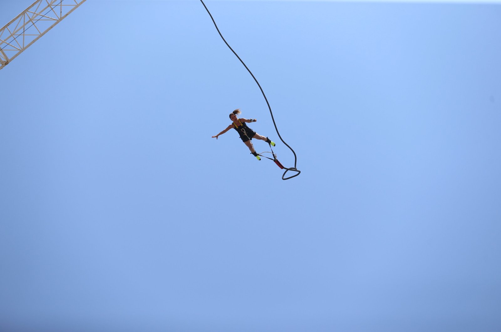 A woman is enjoying high-adrenaline moments with bungee jumping in Fethiye, Muğla, southwestern Türkiye, July 18i 2024. (AA Photo)