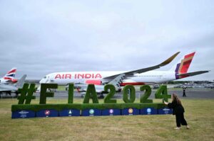 A visitor takes a photograph of a FIA2024 logo in front of an Air India Airbus A300 on the opening day of the Farnborough International Airshow 2024, southwest of London, Britain, July 22, 2024. (AFP Photo)