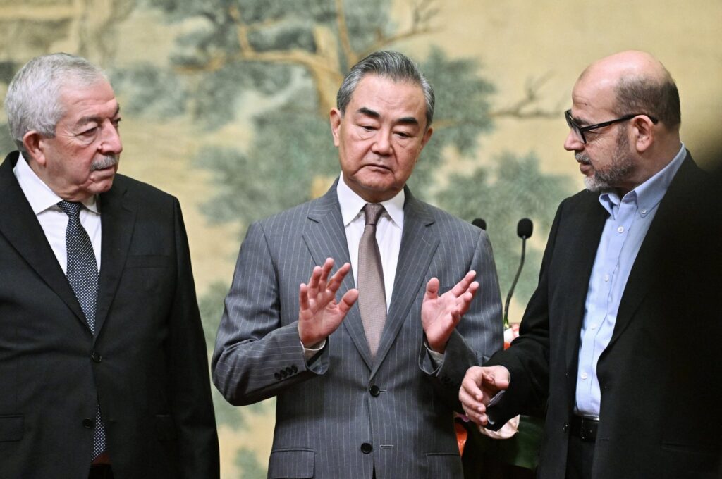 (Left to Right) Mahmoud al-Aloul, Vice Chairman of the Central Committee of Palestinian organization and political party Fatah, China's Foreign Minister Wang Yi, and Mussa Abu Marzuk, a senior member of the Palestinian resistance movement Hamas, attend an event at the Diaoyutai State Guesthouse in Beijing, China, 23 July 2024. (EPA Photo)