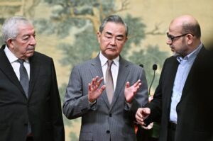 (Left to Right) Mahmoud al-Aloul, Vice Chairman of the Central Committee of Palestinian organization and political party Fatah, China's Foreign Minister Wang Yi, and Mussa Abu Marzuk, a senior member of the Palestinian resistance movement Hamas, attend an event at the Diaoyutai State Guesthouse in Beijing, China, 23 July 2024. (EPA Photo)