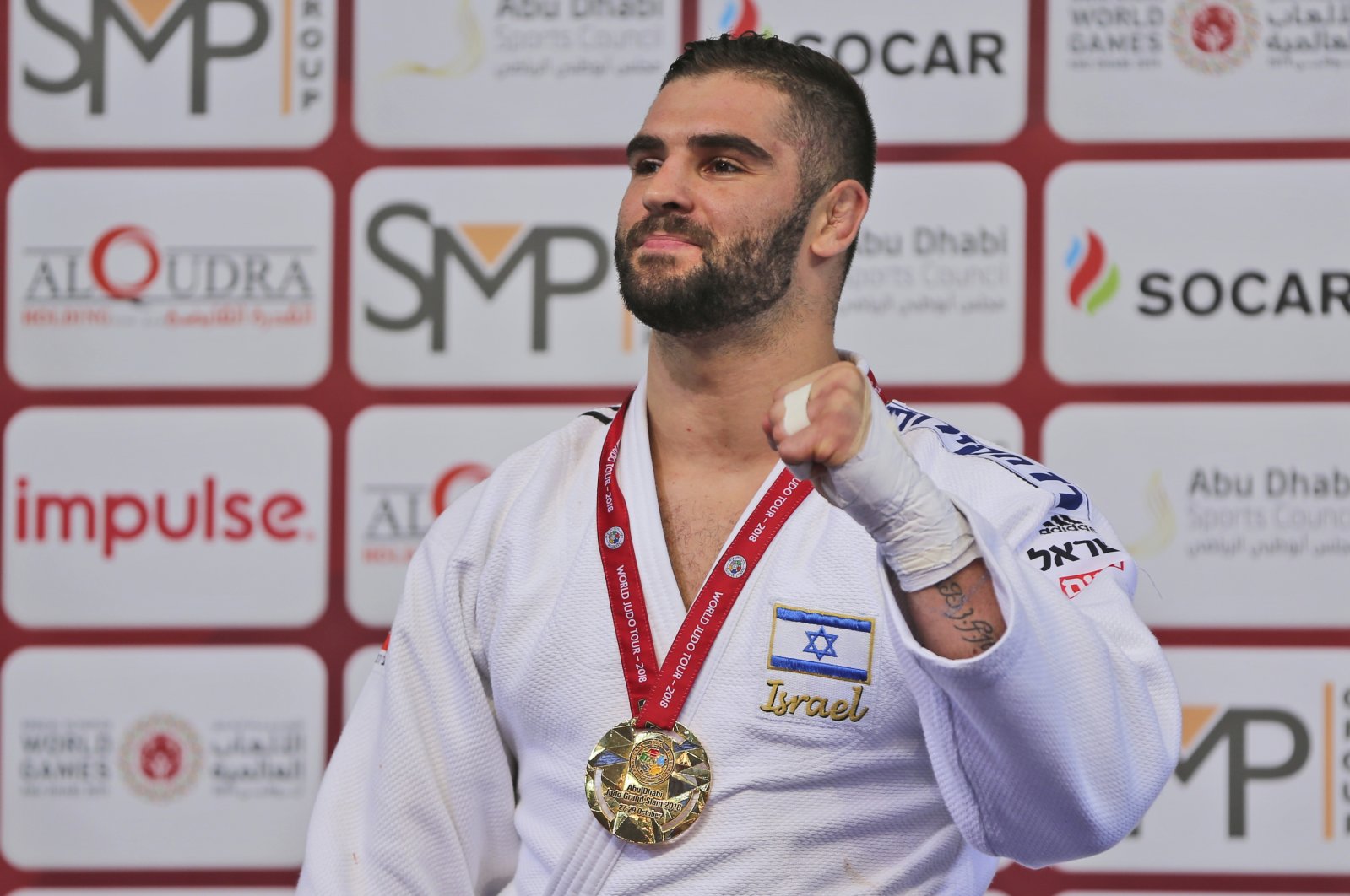 Israel's Peter Paltchik poses with his gold medal during the Abu Dhabi Grand Slam Judo tournament in Abu Dhabi, UAE, Oct. 29, 2018. (AP Photo)