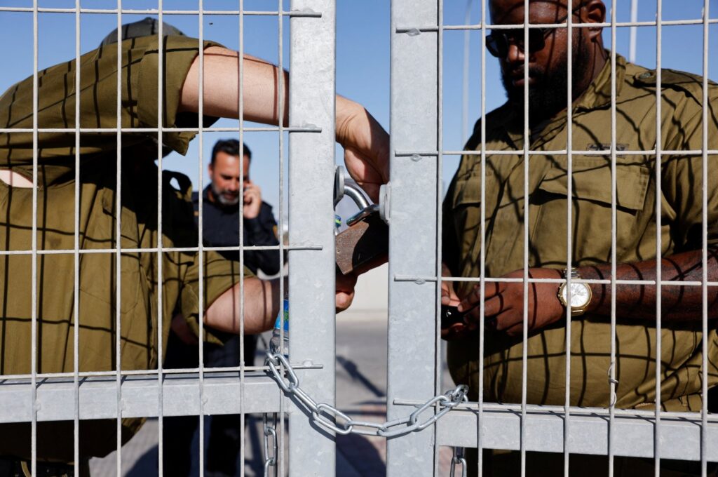 Soldiers lock a gate from the inside at the controversial Sde Teiman detention facility, after Israeli military police arrived at the site as part of an investigation into the abuse of a Palestinian detainee, near Beersheba, southern Israel, July 29, 2024. (Reuters Photo)