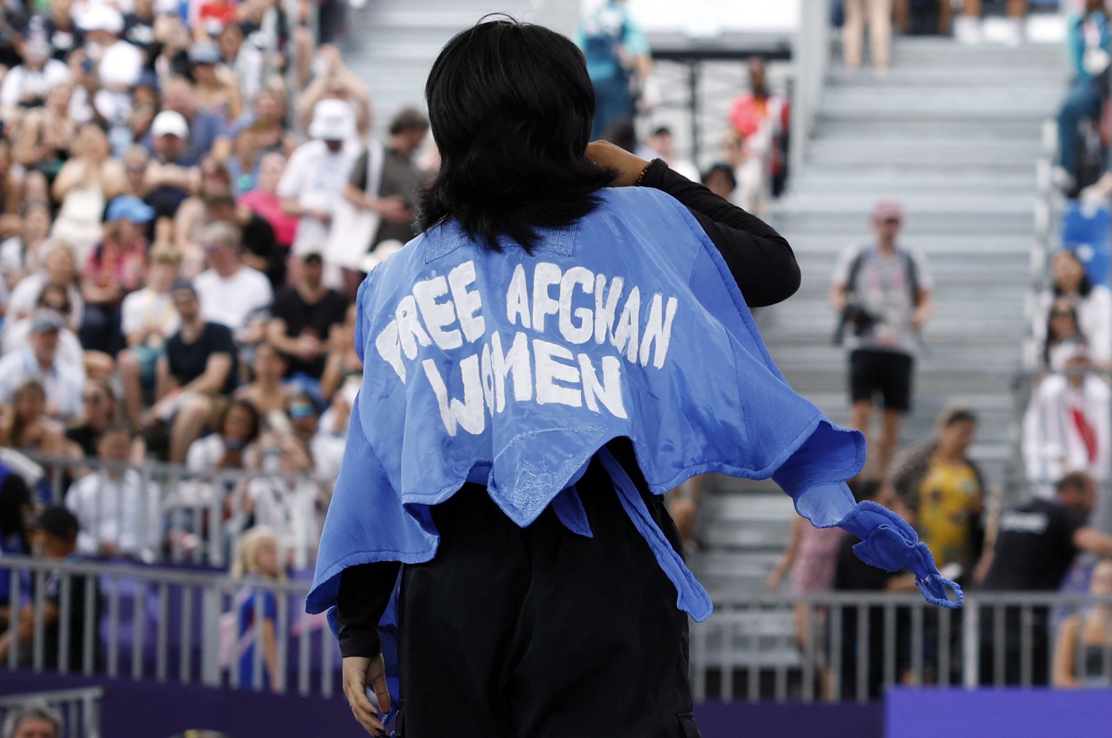 Refugee Olympic team's Manizha Talash, known as Manizha, wears a jacket reading "Free Afghan women" as she competes in the Women's Breaking dance qualifying round of the Paris 2024 Olympic Games at La Concorde, Paris, France, Aug. 9, 2024. (AFP Photo)