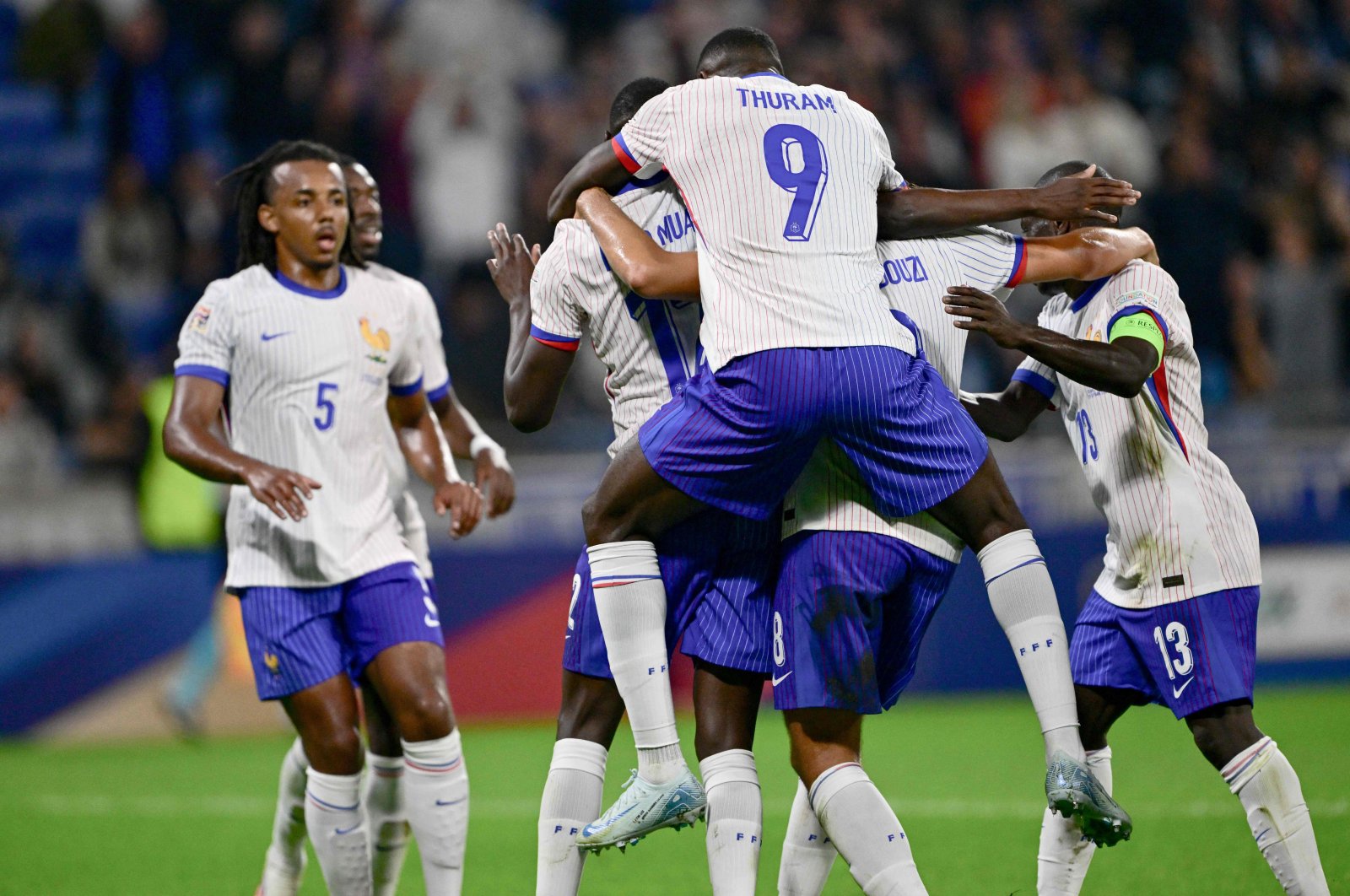 France's Marcus Thuram (C) congratulates Randal Kolo Muani's goal during the UEFA Nations League, League A Group 2 first leg football match between France and Belgium at the Parc Olympique Lyonnais, Lyon, France, Sept. 9, 2024. (AFP Photo)