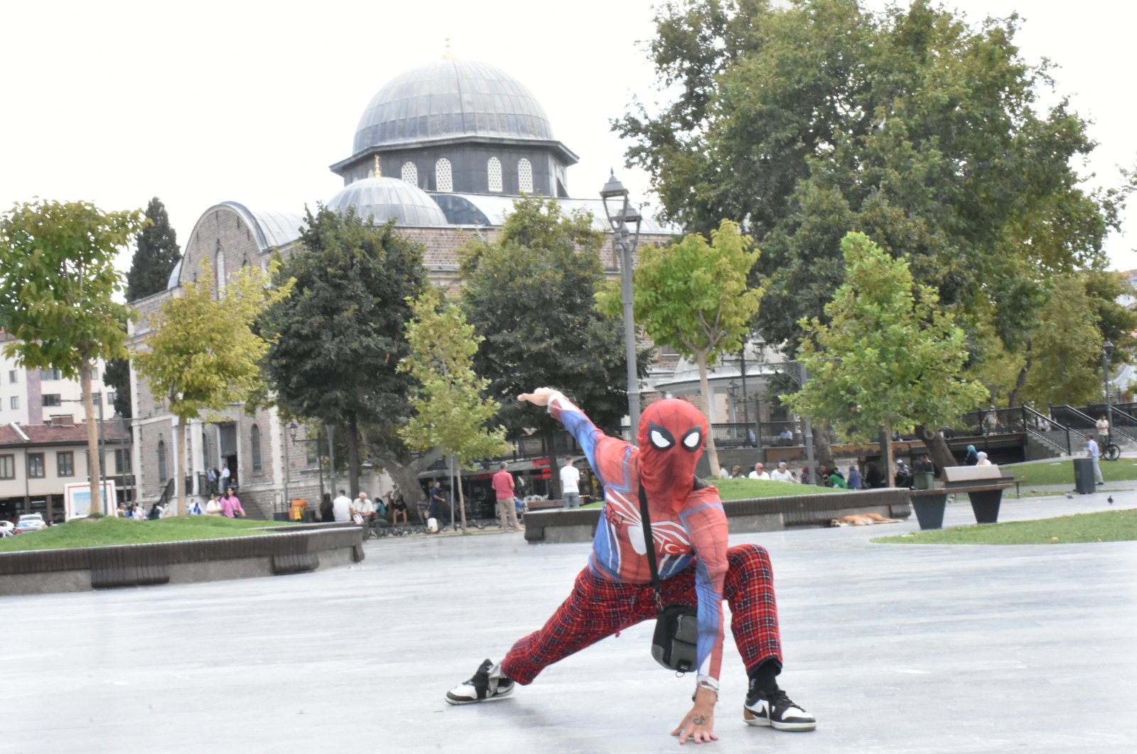 Ayaz Koç, known as "Turkish Spider-Man," poses in front of a historic mosque during his nationwide tour, Balıkesir, western Türkiye, Sept. 12, 2024. (AA Photo)