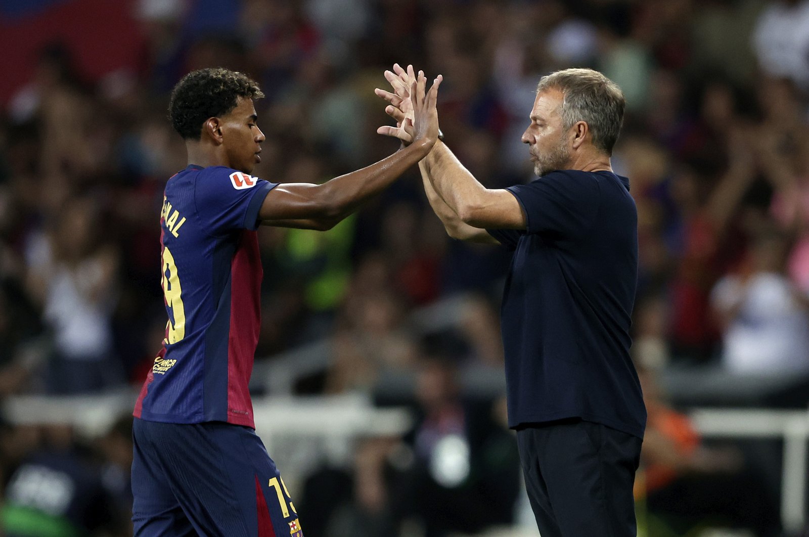 Barcelona's Lamine Yamal (L) and coach Hansi Flick during the La Liga match against Athletic Bilbao at the Lluis Companys Olympic Stadium, Barcelona, Spain, Aug. 24, 2024. (Getty Images Photo)