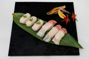 A plate of sushi made from raw fin whale meat is displayed at the exhibition at Tokyo's Toyosu market, Japan, Sept. 13, 2024. (AFP P hoto)