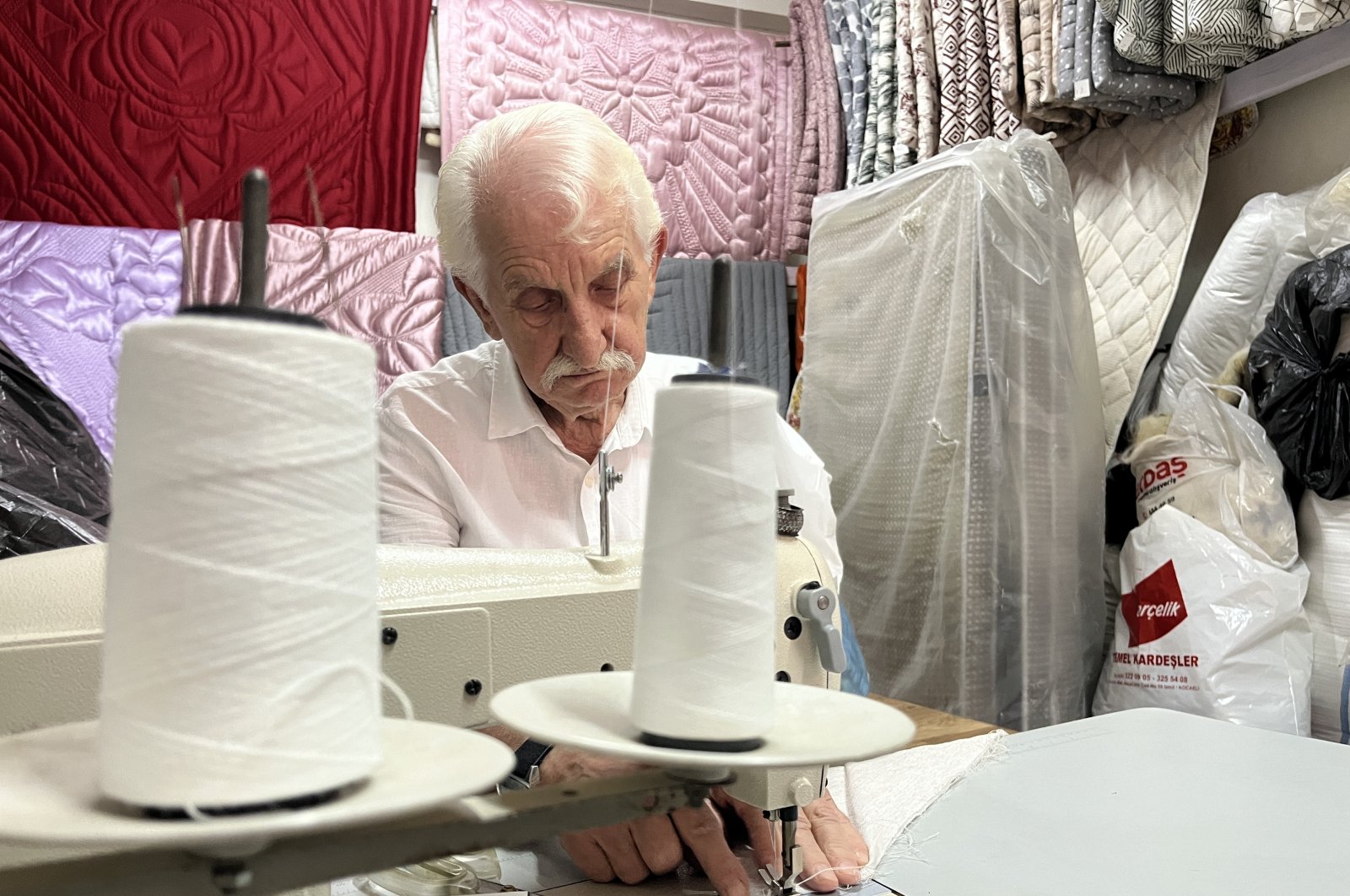 After decades, Ismail Çevikel continues to quilt in his shop, Izmit, Türkiye, Sept. 22, 2024. (IHA Photo)