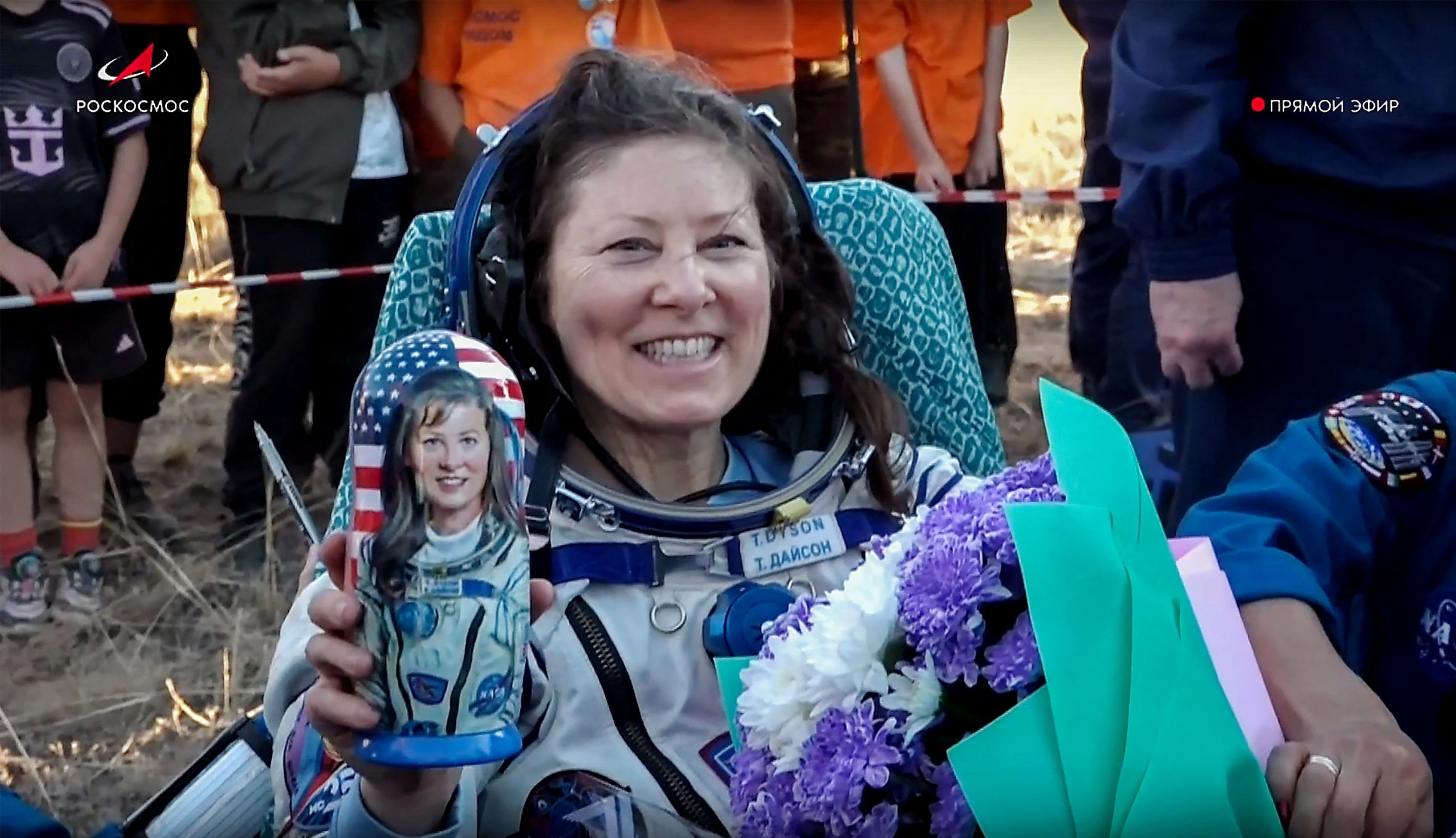 347284 NASA astronaut Tracy Dyson holds a traditional Russian Matryoshka wooden doll depicting her, shortly after the landing of the Russian Soyuz MS-25 capsule in a remote area near the town of Dzhezkazgan, Kazakhstan. Two Russian cosmonauts, Oleg Kononenko and Nikolai Chub who spent 374 days in low-Earth orbit at the ISS, the longest time anybody has ever stayed on the station in a continuous stint, landed back on Earth on Sept. 23, 2024. (EPA/Roscosmos Handout)