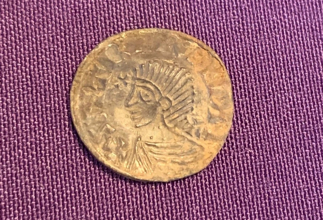 A view of a coin depicting King Sihtric Silkbeard from a rare hoard of 1,000-year-old silver coins unearthed during metal-detecting in Douglas, Isle of Man, in this handout released on Oct. 1, 2024. (Reuters Photo)