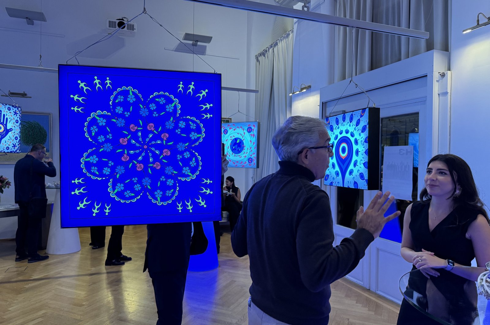 Artwork and visitors at the "Symbol of Dances" exhibition, Vienna, Austria, Oct. 3, 2024. (AA Photo)