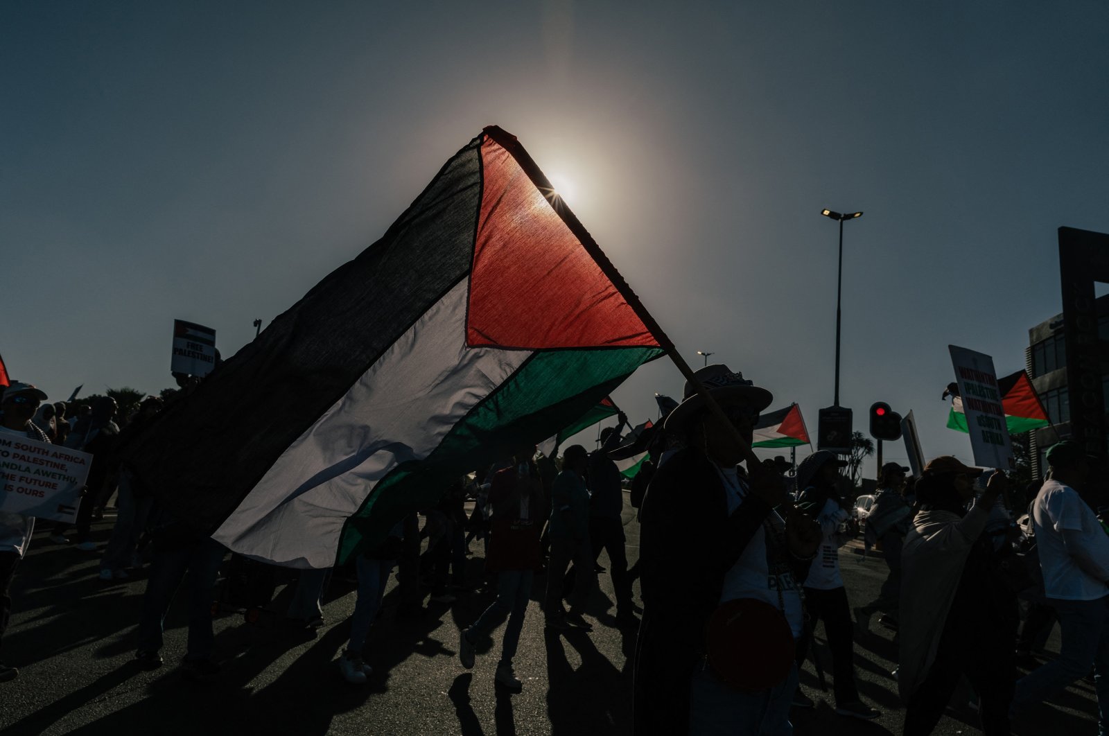 Pro-Palestinian activists hold placards and wave Palestinian flags during a march against Israel's attacks, Durban, South Africa, Oct. 5, 2024. (AFP Photo)