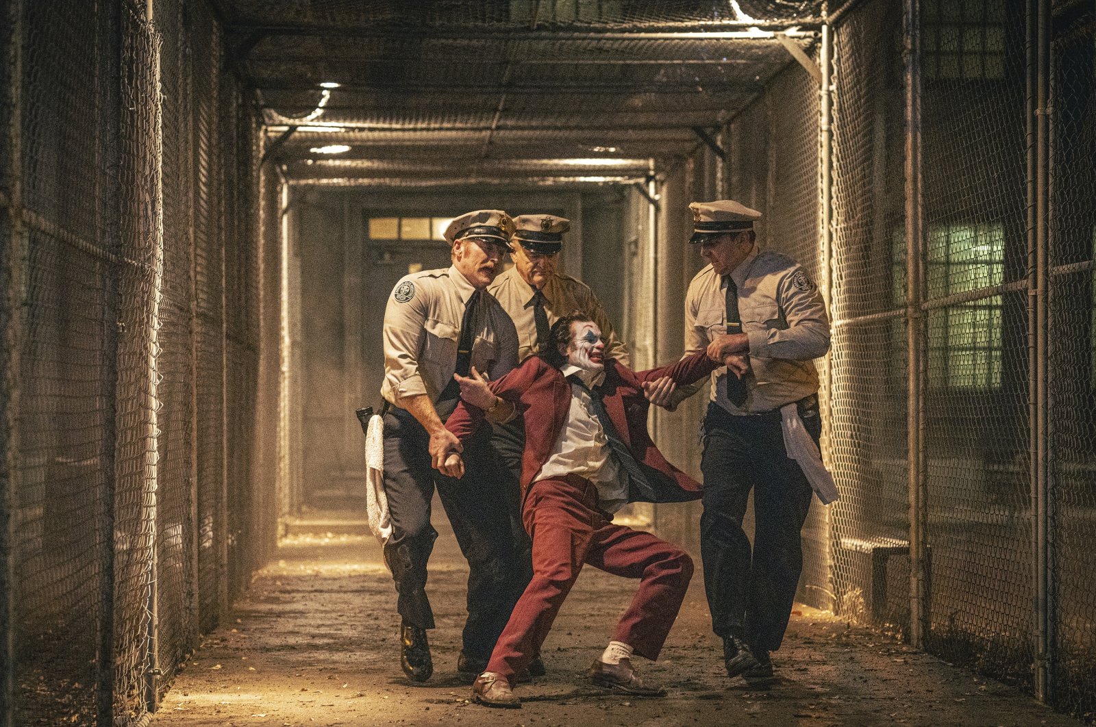Joaquin Phoenix (foreground C) and Brendan Gleeson (background C) in a scene from "Joker: Folie a Deux." (Warner Bros. via AP Photo)