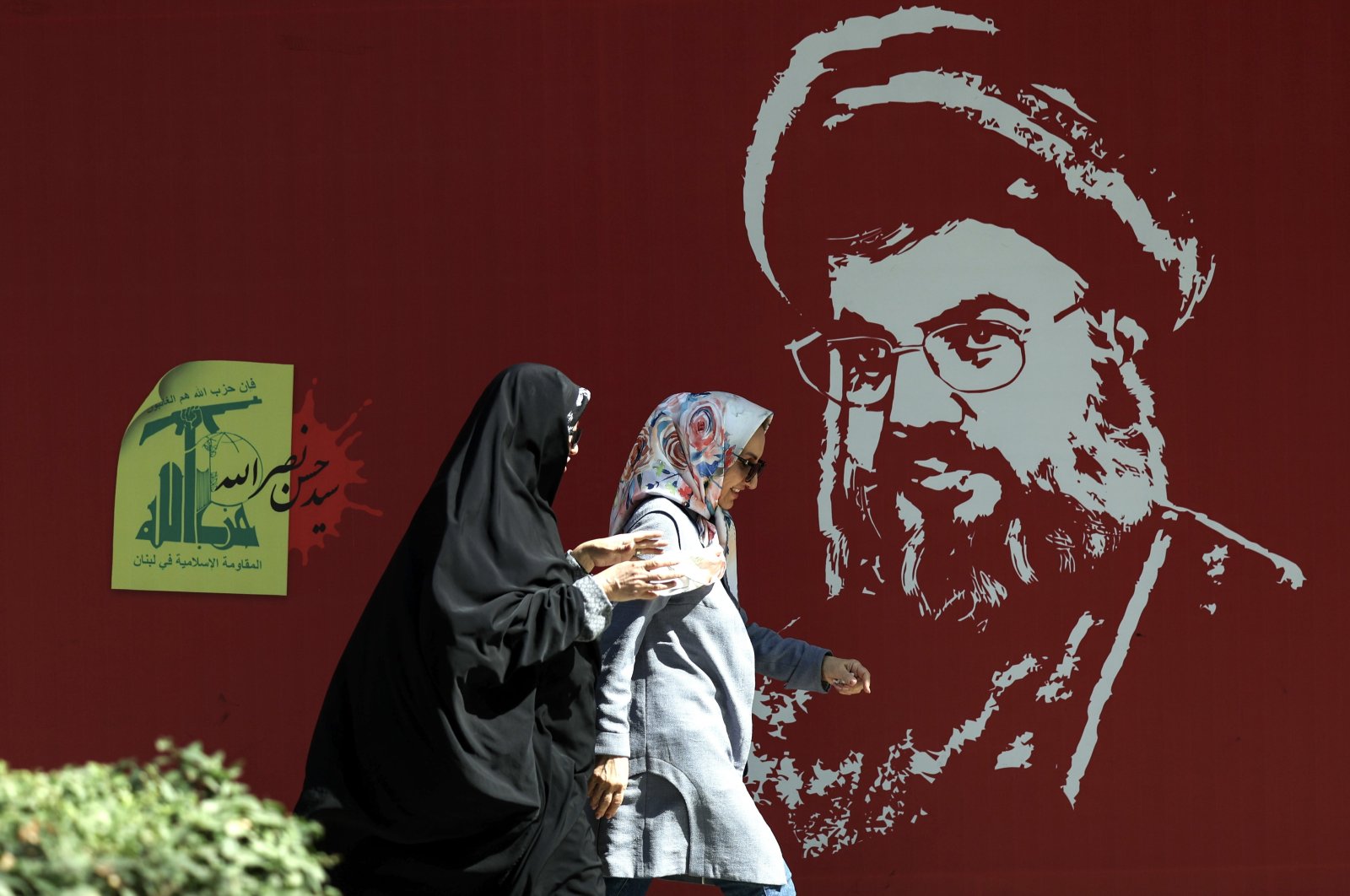 Iranian women walk past a portrait of late Hezbollah leader Hassan Nasrallah displayed in a street, Tehran, Iran, Oct. 7, 2024. (EPA Photo)