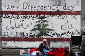 A displaced woman looks on next to her makeshift encampment on the street at Beirut's central Martyrs' Square, where many families spent the night while fleeing the overnight Israeli strikes in southern Beirut, Lebanon, Oct. 9, 2024. (Reuters Photo)