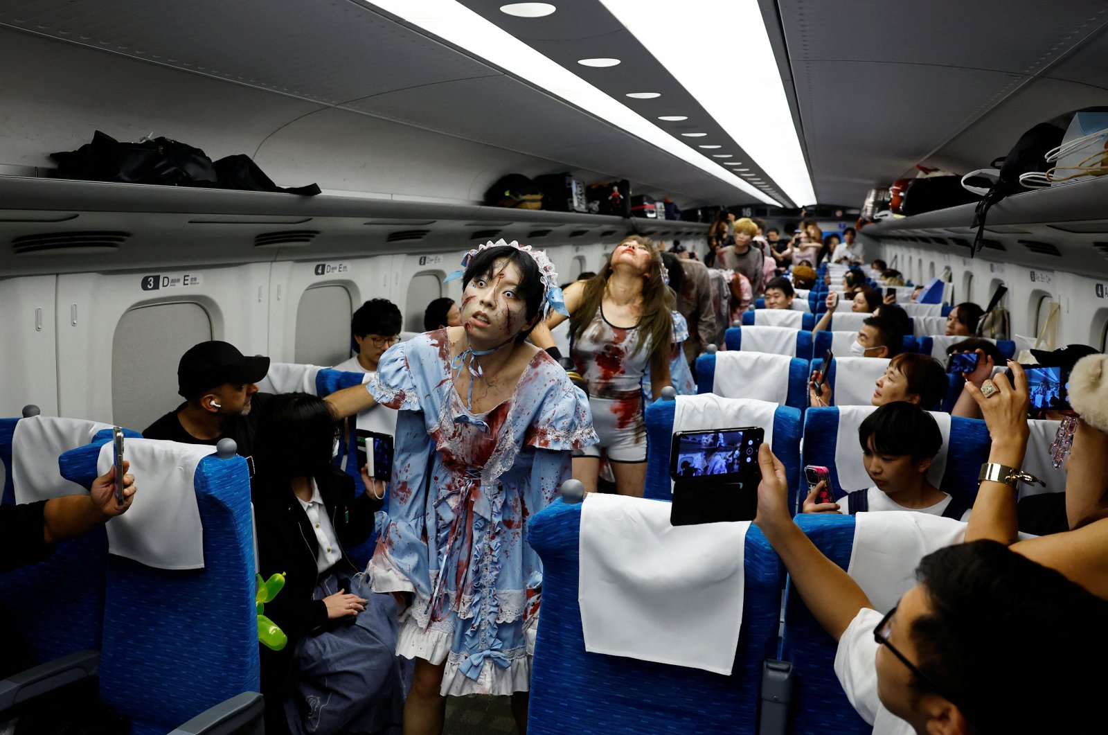 People dressed as zombies perform inside a "Zombie Shinkansen" bullet train bound for Osaka from Tokyo, inspired by the South Korean movie "Train to Busan," ahead of the Halloween season, Tokyo, Japan, Oct. 19, 2024. (Reuters Photo)