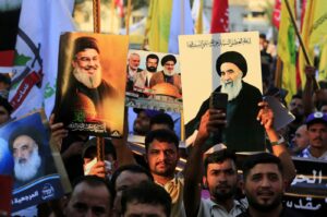Supporters of the Iran-backed Iraqi Shiite Popular Mobilization Forces carry images of late Hezbollah leader Hassan Nasrallah and Iraq's top religious authority, Ayatollah Ali al-Sistani, as they take part in a demonstration in solidarity with the Palestinian and Lebanese people, Al-Tahrir Square, Baghdad, Iraq, Oct. 11, 2024. (EPA Photo)