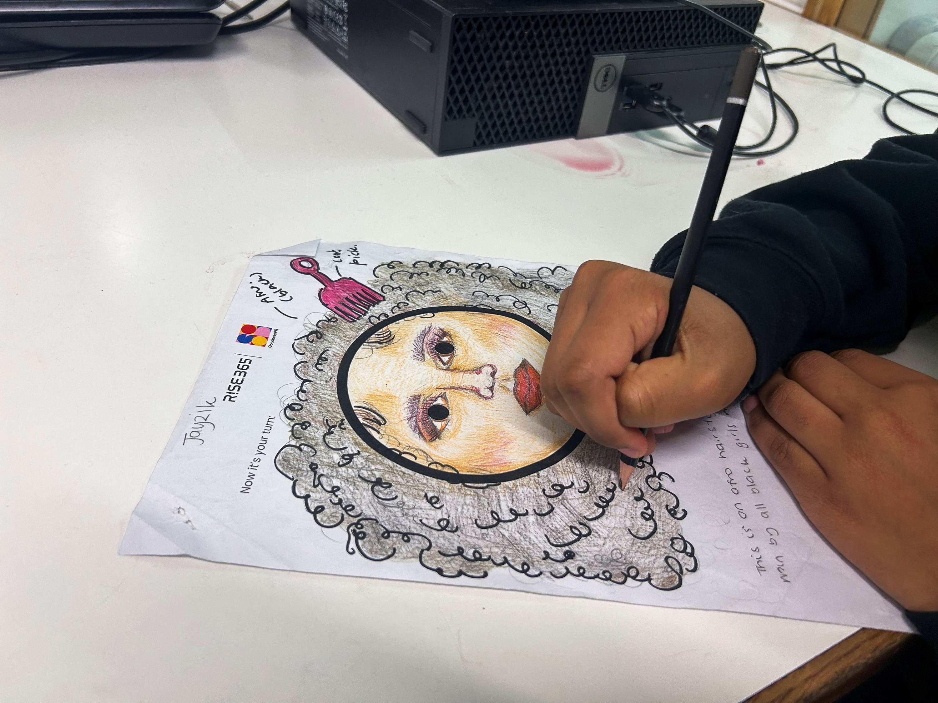 351946 Student and Rise 365 young designer Jayzik Duckoo draws Afro hair emoji at the Concorde Youth Club, Hackney, east London, U.K., Oct. 21, 2024. (Reuters Photo)